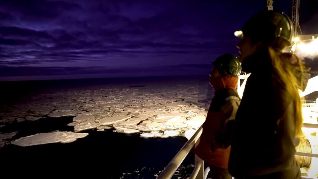 two people on a ship in the arctic